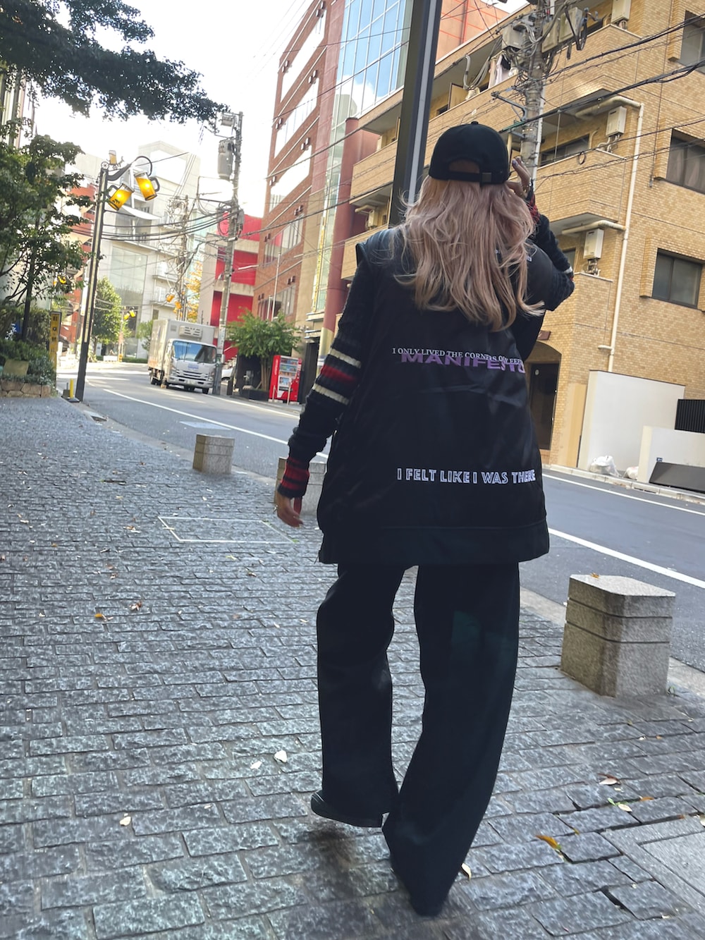 ブラック系のその他パンツ、ブラック系のスニーカー、ブラック系のキャップを着用したレディースの秋コーディネートの2枚目の写真