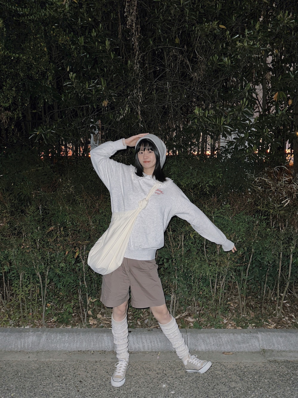 ベージュ系のスニーカー、ホワイト系のショルダーバッグ、グレー系のスウェットを着用したレディースの春コーディネートの2枚目の写真