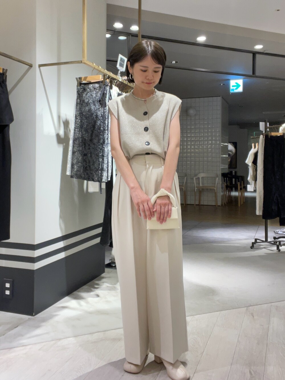 ホワイト系のその他パンツ、ベージュ系のニット/セーター、ホワイト系のバッグを着用したレディースの夏コーディネートの2枚目の写真