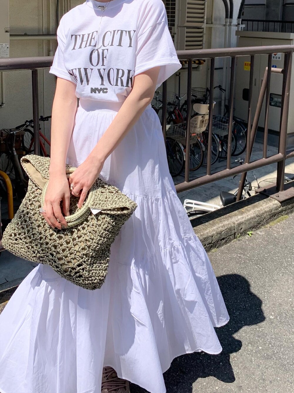 ホワイト系のTシャツ/カットソー、ホワイト系のスカート、シルバー系のその他シューズを着用したレディースの春コーディネートの3枚目の写真