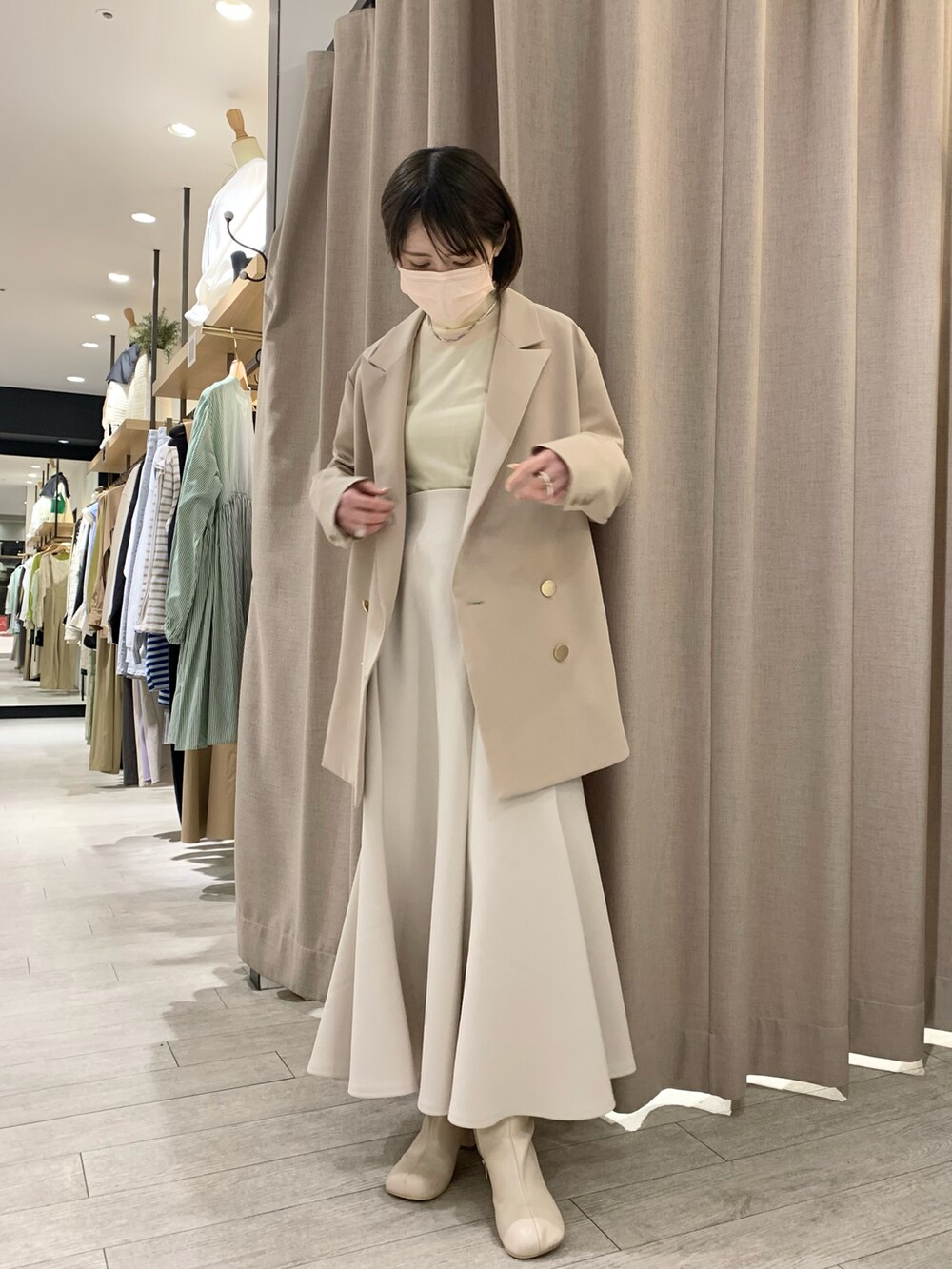 ベージュ系のテーラードジャケット、ベージュ系のTシャツ/カットソー、ホワイト系のスカートを着用したレディースの春コーディネートの2枚目の写真