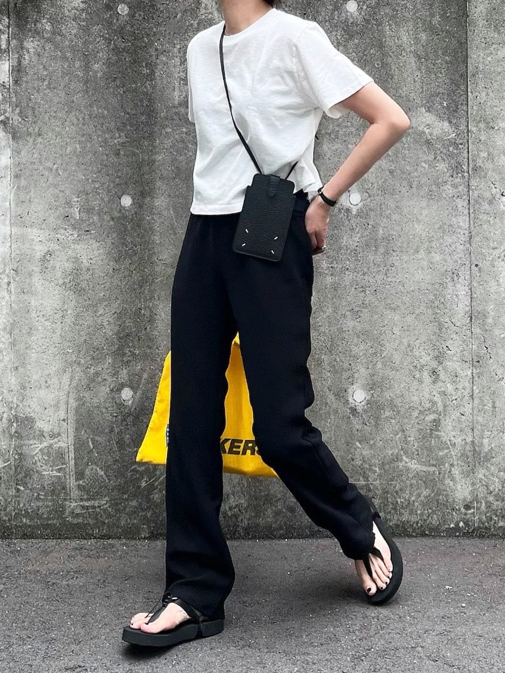 ブラック系のその他パンツ、ブラック系のスマホケース/カバーを着用したレディースの夏コーディネートの2枚目の写真