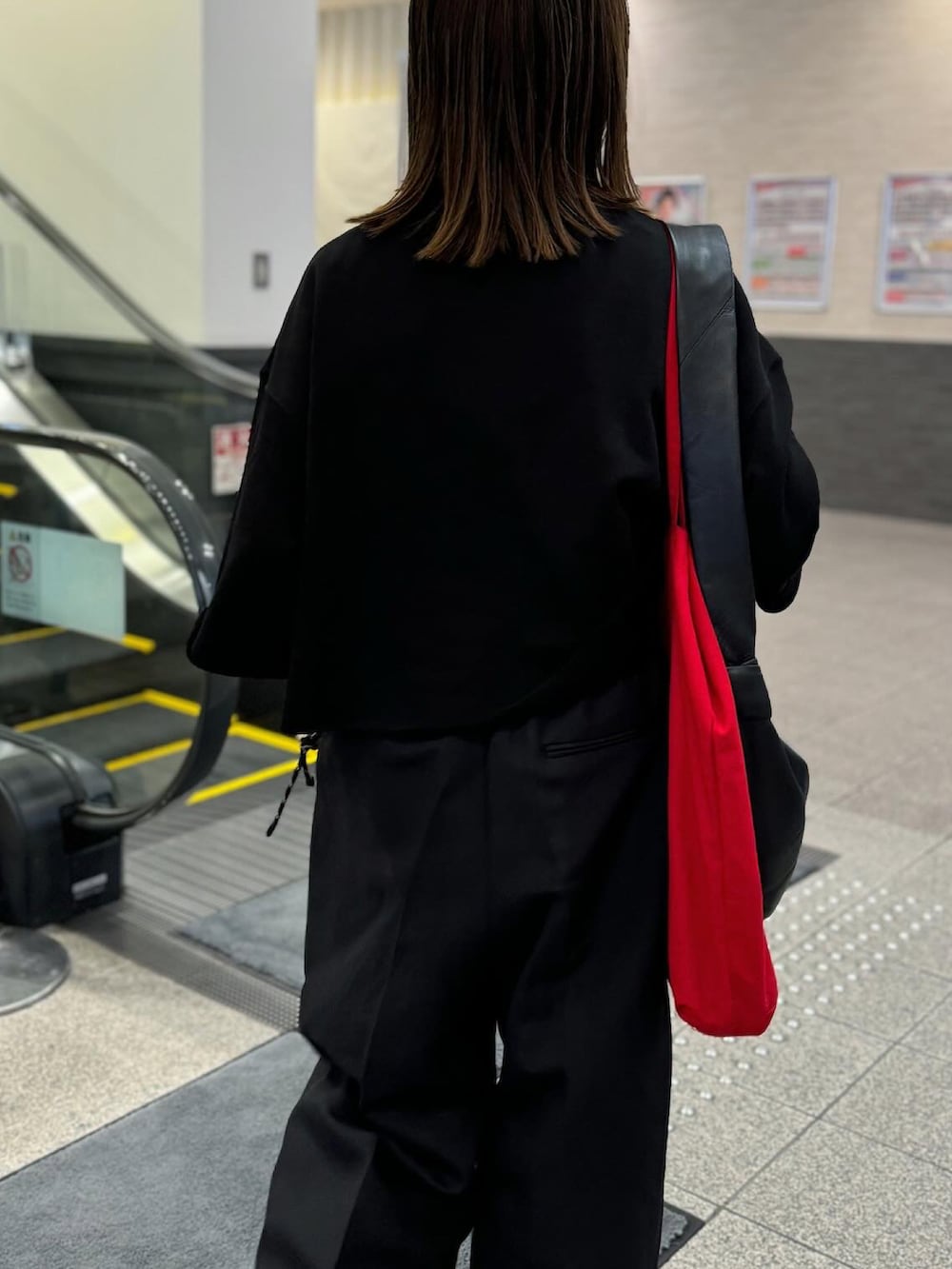 ブラック系のTシャツ/カットソー、ブラック系のパンツ、ブラック系のショルダーバッグを着用したレディースの夏コーディネートの4枚目の写真