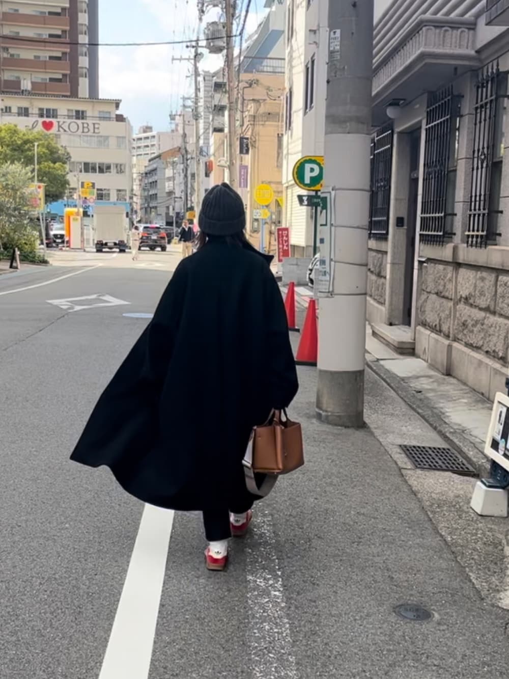 ブラック系のジャケット/アウター、ブラック系のパンツ、レッド系のスニーカーを着用したレディースの秋コーディネートの3枚目の写真