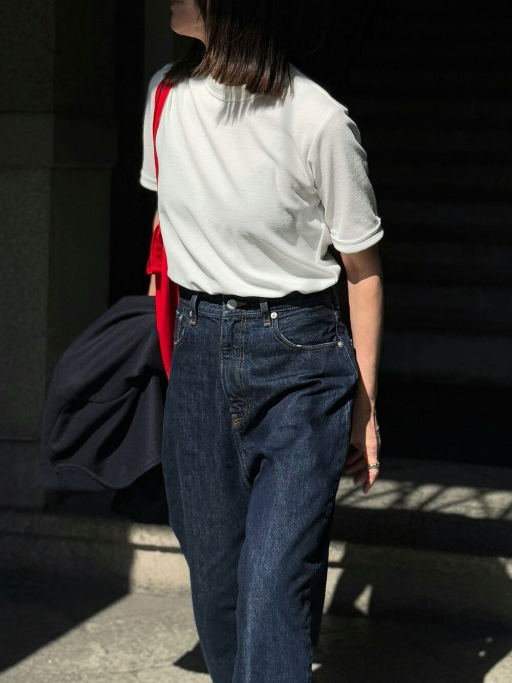 ホワイト系のTシャツ/カットソー、ブルー系のデニムパンツを着用したレディースの春コーディネートの3枚目の写真