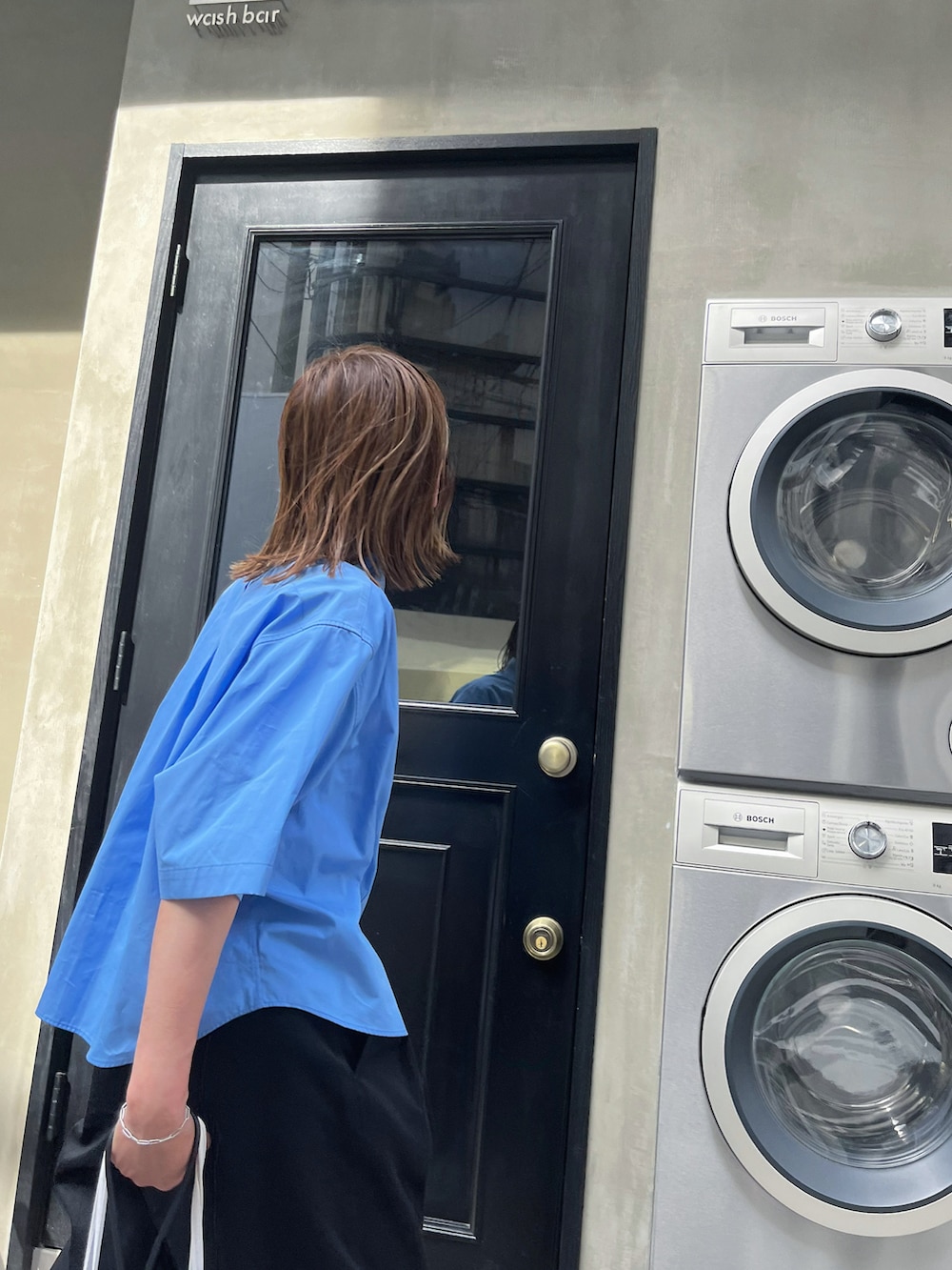 ブルー系のシャツ/ブラウス、ブラック系のチノパンツ、ブラック系のスニーカーを着用したレディースの夏コーディネートの5枚目の写真