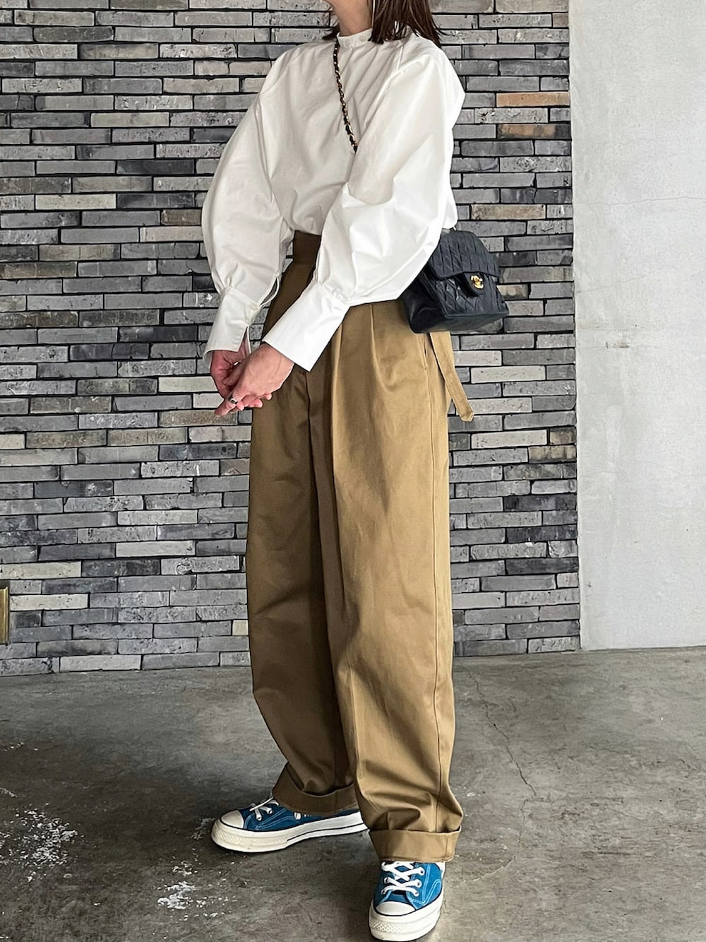 ホワイト系のシャツ/ブラウス、ベージュ系のチノパンツ、ブルー系のスニーカーを着用したレディースの春コーディネートの2枚目の写真