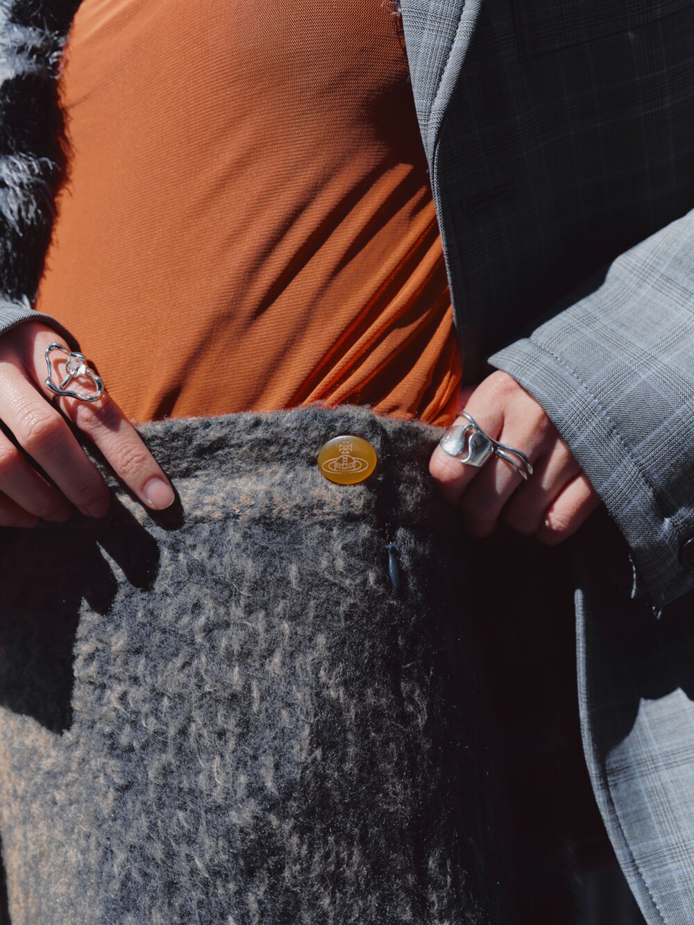 オレンジ系のTシャツ/カットソー、グレー系のテーラードジャケット、ブラウン系のスカートを着用したレディースの春コーディネートの2枚目の写真