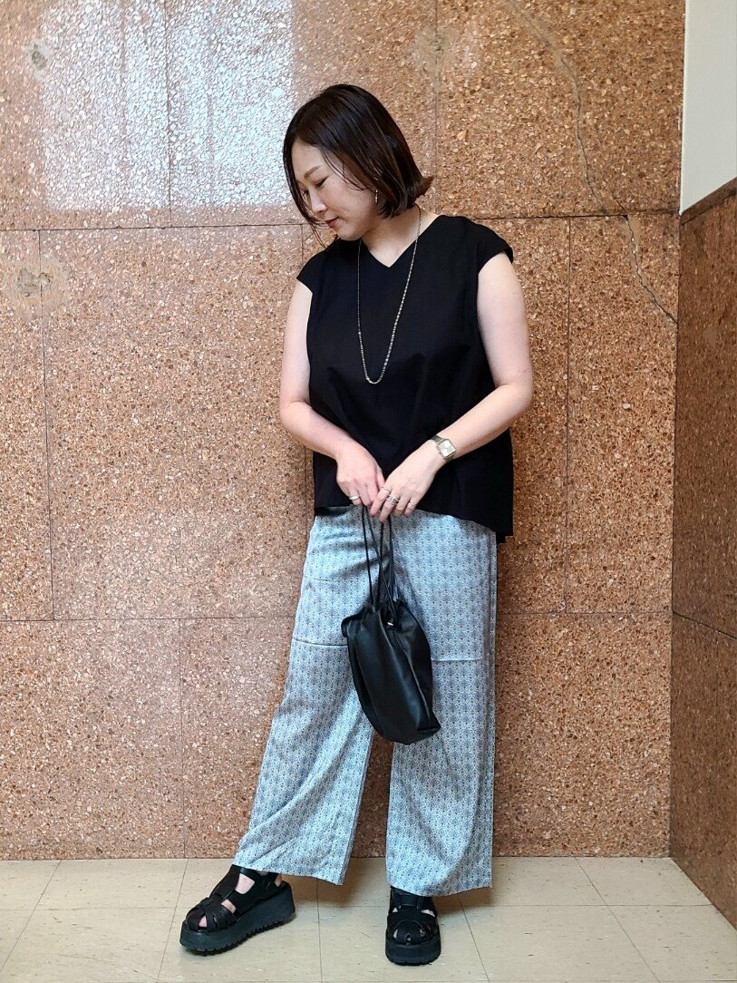 ブラック系のシャツ/ブラウス、ベージュ系のその他パンツ、ブラック系のショルダーバッグを着用したレディースの夏コーディネートの2枚目の写真