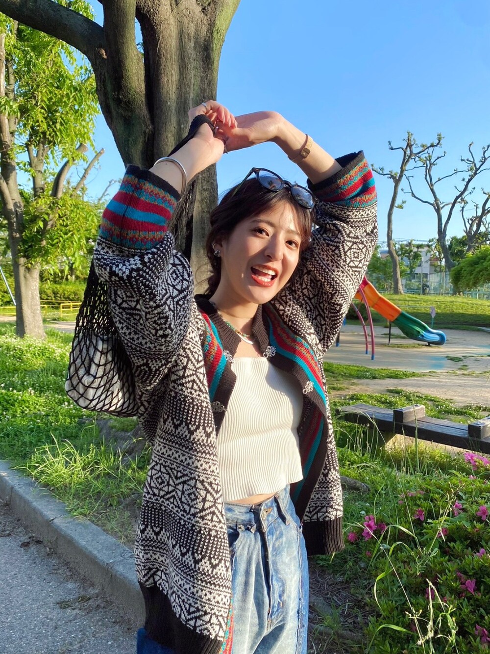 ブラック系のカーディガン/ボレロ、ブルー系のデニムパンツを着用したレディースの春コーディネートの3枚目の写真