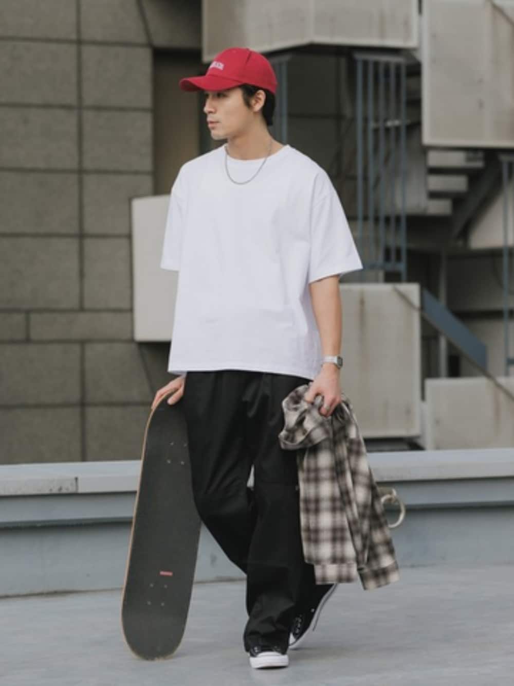 ホワイト系のTシャツ/カットソー、ブラック系のチノパンツを着用したメンズの春コーディネートの2枚目の写真