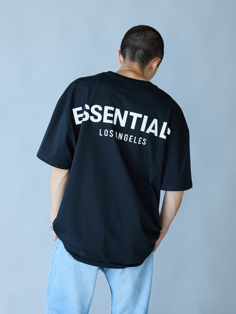 ブラック系のTシャツ/カットソー、ブルー系のデニムパンツを着用したメンズの春コーディネートの2枚目の写真