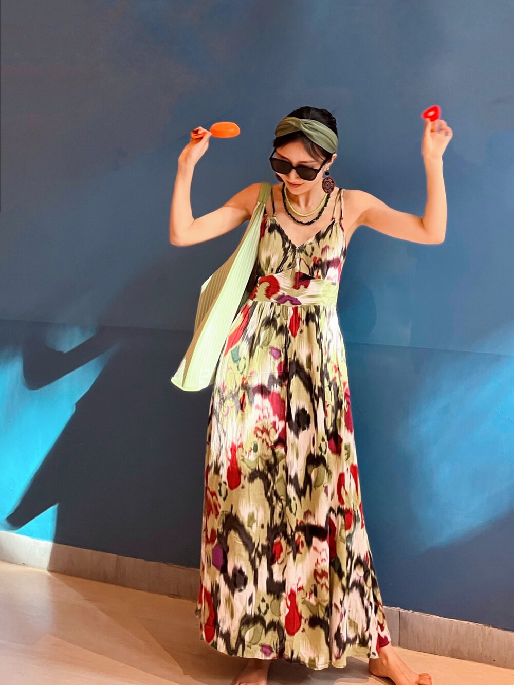 グリーン系のショルダーバッグを着用したレディースの夏コーディネートの2枚目の写真