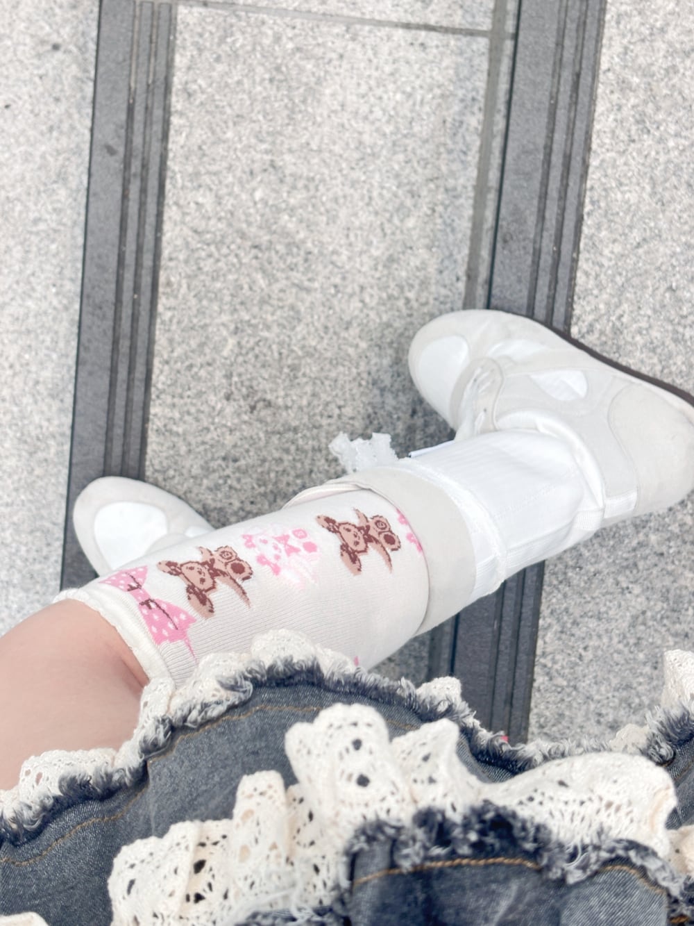 ホワイト系のトップス、ブルー系のデニムスカート、ホワイト系のブーツを着用したレディースの夏コーディネートの2枚目の写真