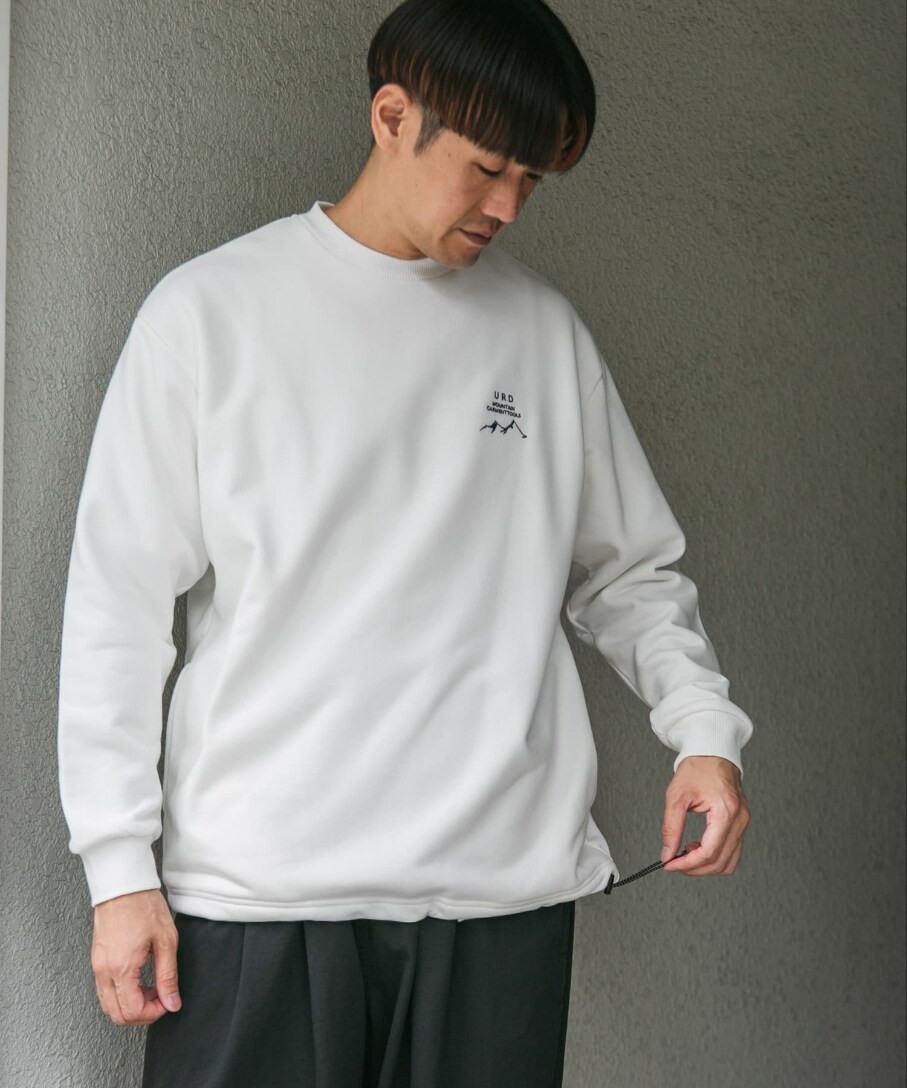 ホワイト系のスウェット、ブラック系のチノパンツを着用したメンズの秋コーディネートの2枚目の写真