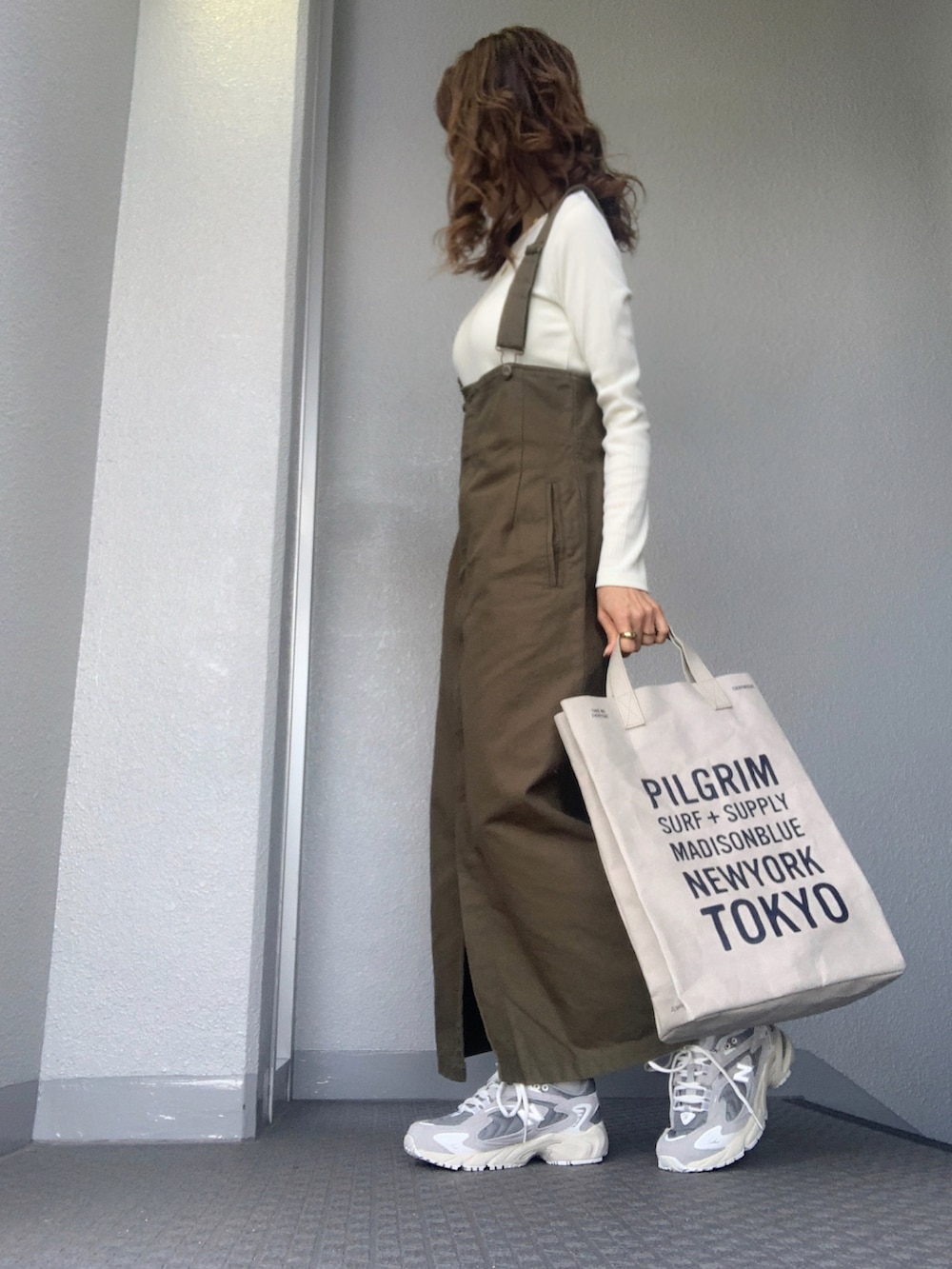 ホワイト系のTシャツ/カットソー、グレー系のスニーカーを着用したレディースの冬コーディネートの4枚目の写真
