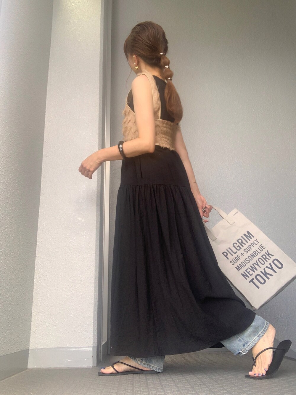 ブラック系のワンピースを着用したレディースの夏コーディネートの2枚目の写真