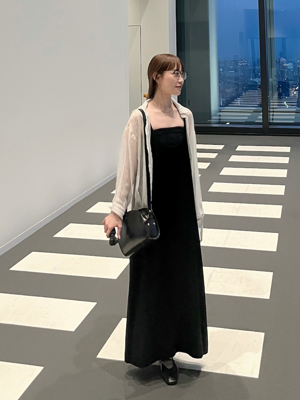 ブラック系のワンピース、ブラック系のショルダーバッグ、ブラック系のチューブトップを着用したレディースの秋コーディネートの3枚目の写真