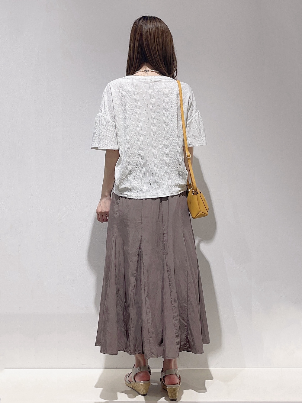 ホワイト系のTシャツ/カットソー、ブラウン系のスカート、シルバー系のネックレスを着用したレディースの夏コーディネートの3枚目の写真