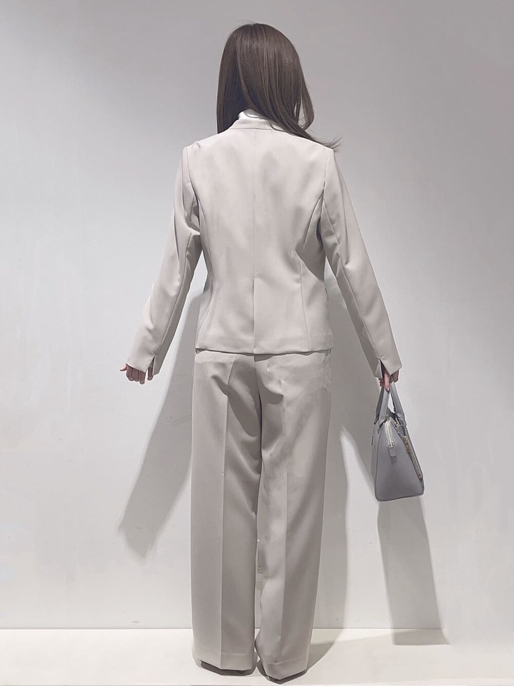 ベージュ系のノーカラージャケット、ホワイト系のシャツ/ブラウス、ベージュ系のその他パンツを着用したレディースの冬コーディネートの3枚目の写真