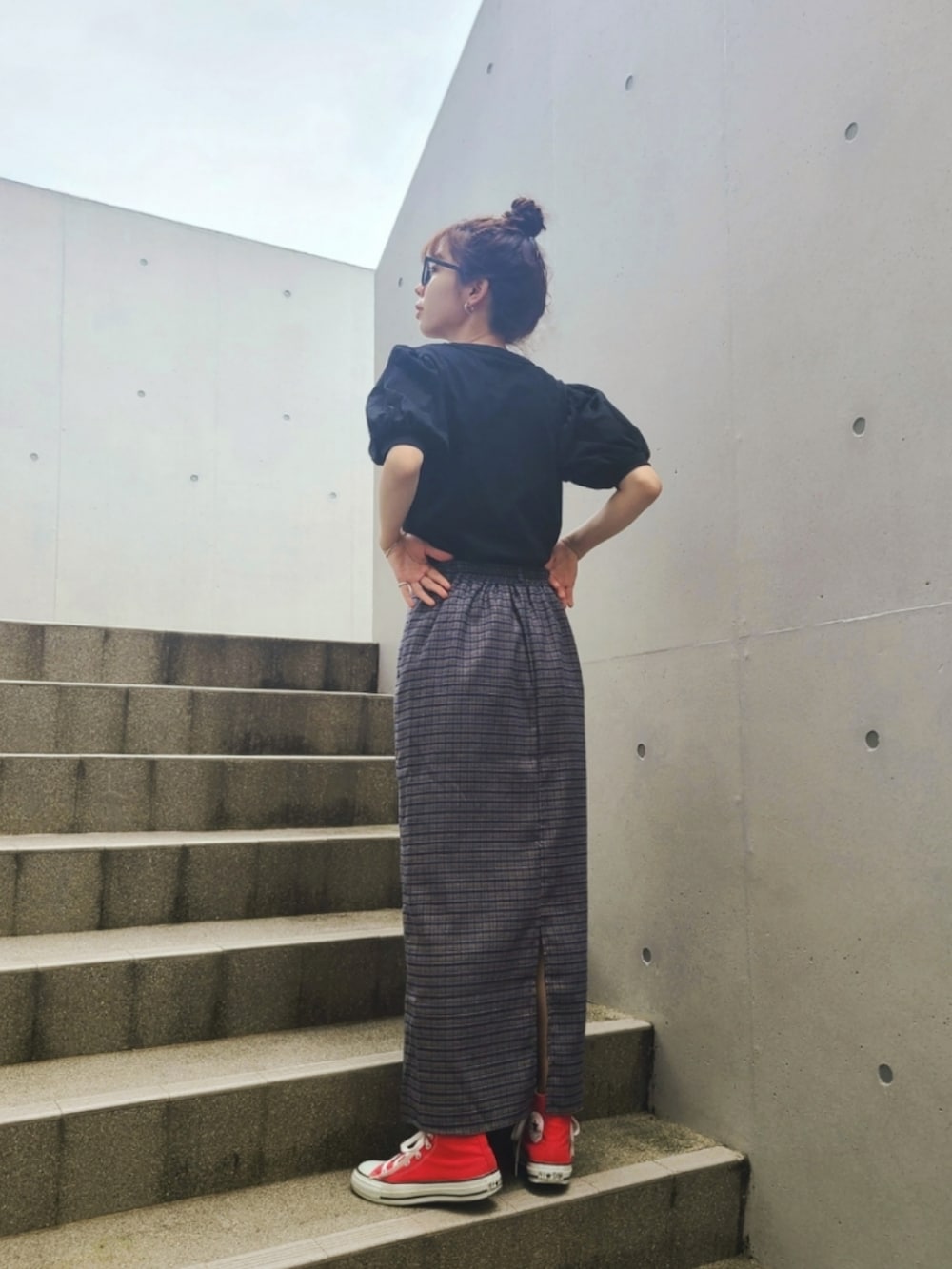 ブラック系のTシャツ/カットソー、ブルー系のスカート、レッド系のスニーカーを着用したレディースの夏コーディネートの2枚目の写真