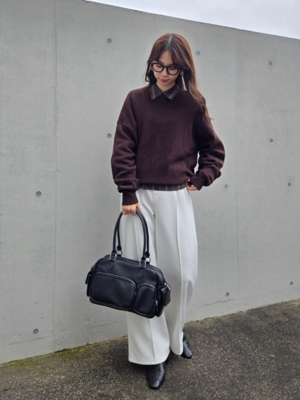ブラウン系のニット/セーター、グレー系のシャツ/ブラウス、ブラック系のボストンバッグを着用したレディースの秋コーディネートの3枚目の写真
