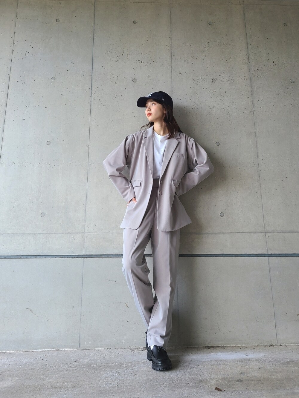 ブラック系のローファー、グレー系のテーラードジャケット、グレー系のスラックスを着用したレディースの秋コーディネートの2枚目の写真