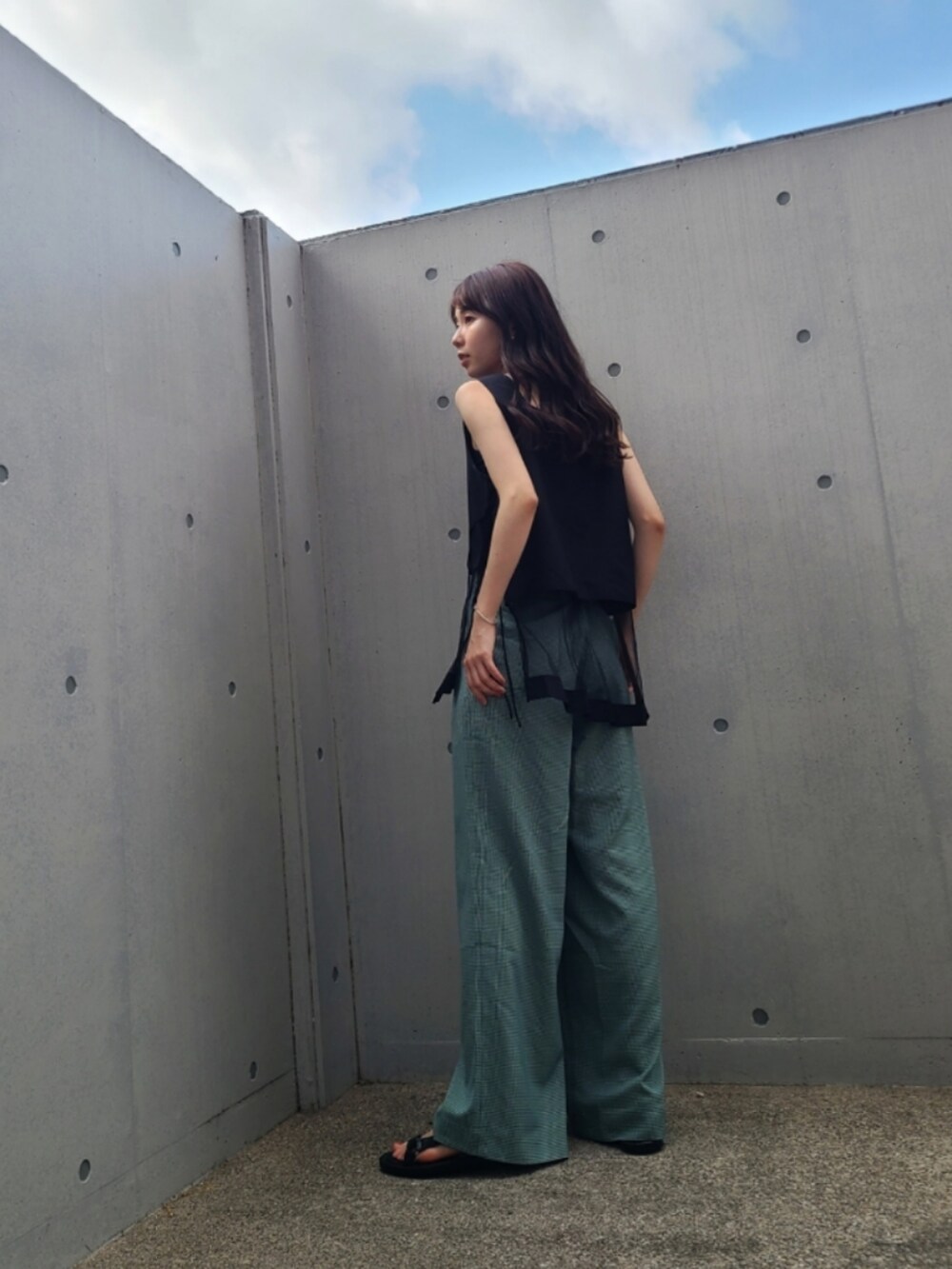 グリーン系のその他パンツ、ブラック系のトップス、ブラック系のサンダルを着用したレディースの夏コーディネートの2枚目の写真