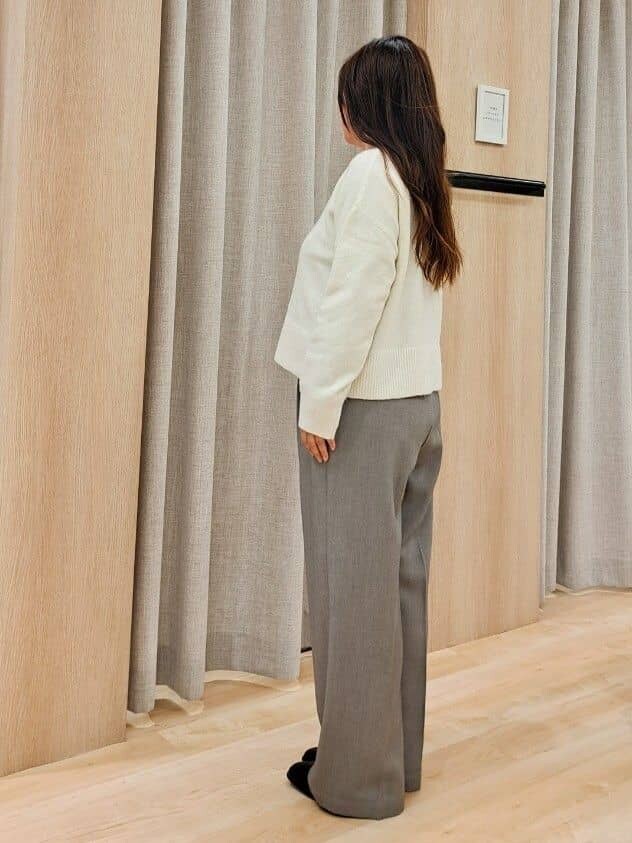 グレー系のステンカラーコート、ホワイト系のニット/セーター、グレー系のその他パンツを着用したレディースの秋コーディネートの8枚目の写真