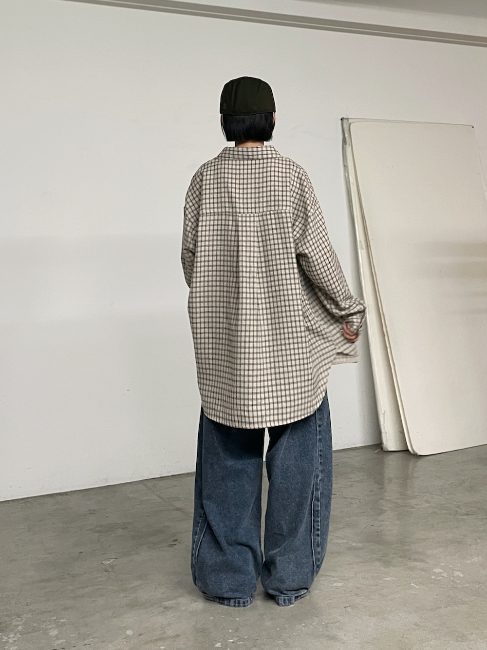 ブルー系のデニムパンツ、ベージュ系のシャツ/ブラウス、ブラウン系のタンクトップを着用したレディースの秋コーディネートの3枚目の写真