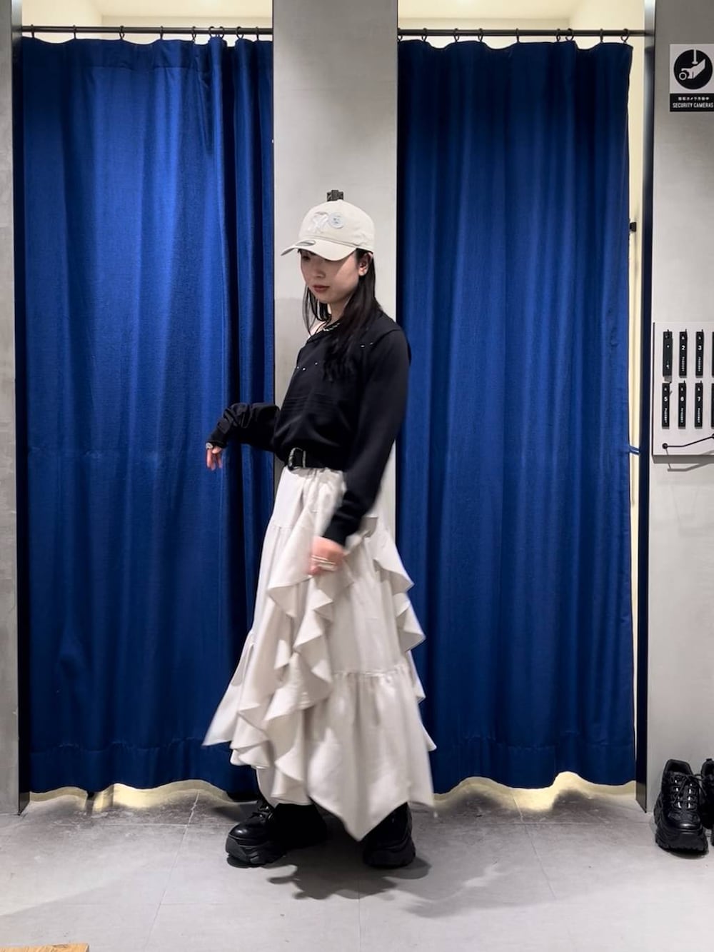 ブラック系のブーツ、ブラック系のキャミソール、ベージュ系のスカートを着用したレディースの春コーディネートの4枚目の写真