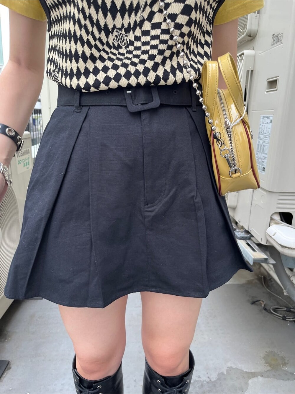 ブラック系のブーツ、ブラック系のニット/セーター、イエロー系のTシャツ/カットソーを着用したレディースの夏コーディネートの9枚目の写真