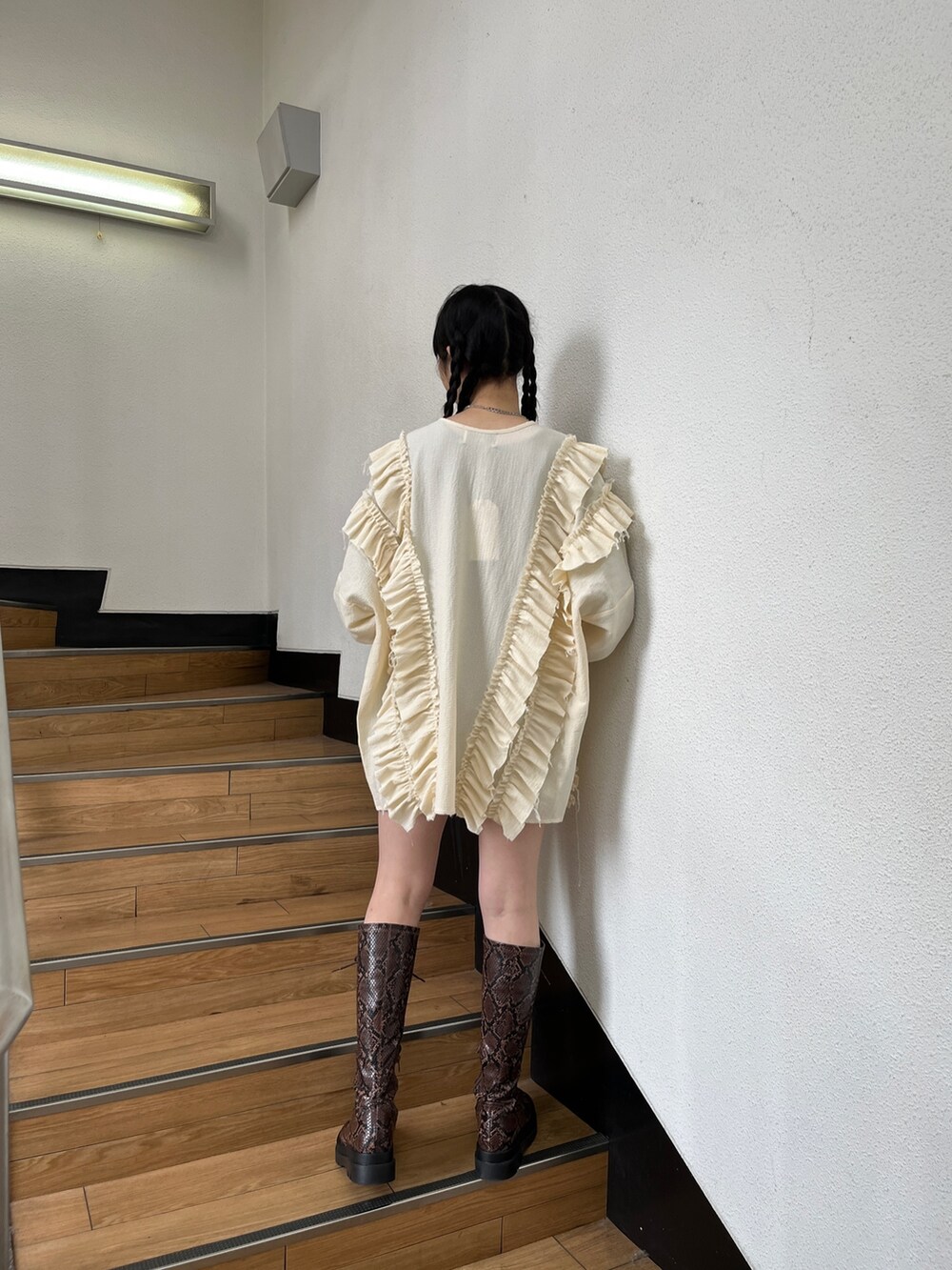 ブラック系のブーツ、ホワイト系のシャツ/ブラウス、ブラック系のデニムパンツを着用したレディースの冬コーディネートの5枚目の写真