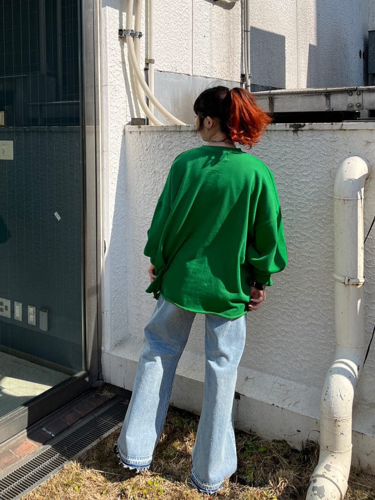 ブルー系のデニムパンツ、グリーン系のスウェットを着用したレディースの春コーディネートの3枚目の写真