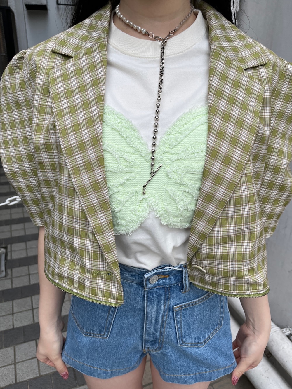 ブルー系のデニムパンツ、ホワイト系のTシャツ/カットソー、グリーン系のテーラードジャケットを着用したレディースの春コーディネートの4枚目の写真