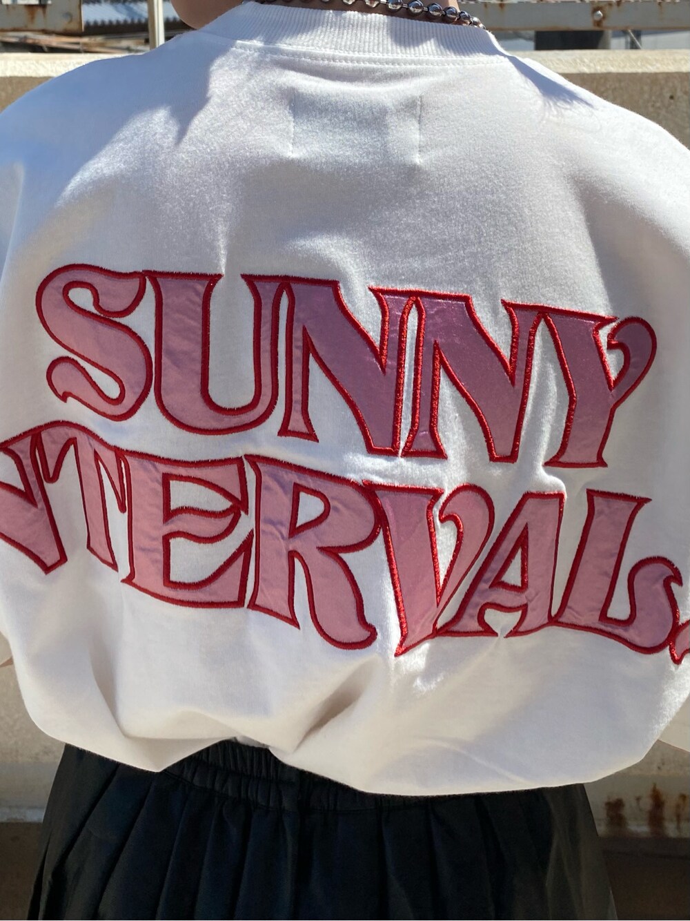 ブラック系のスカート、ホワイト系のTシャツ/カットソーを着用したレディースの春コーディネートの5枚目の写真