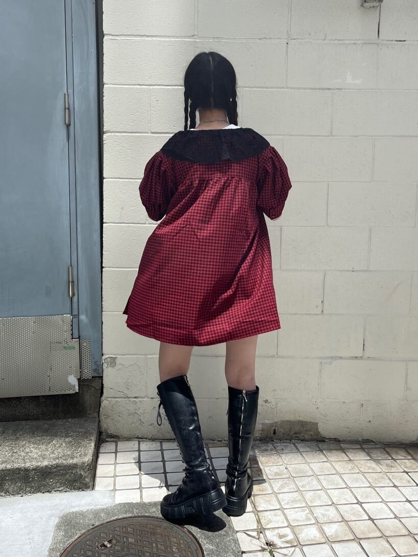 レッド系のシャツ/ブラウス、ブラック系のデニムパンツ、ブラック系のブーツを着用したレディースの夏コーディネートの6枚目の写真