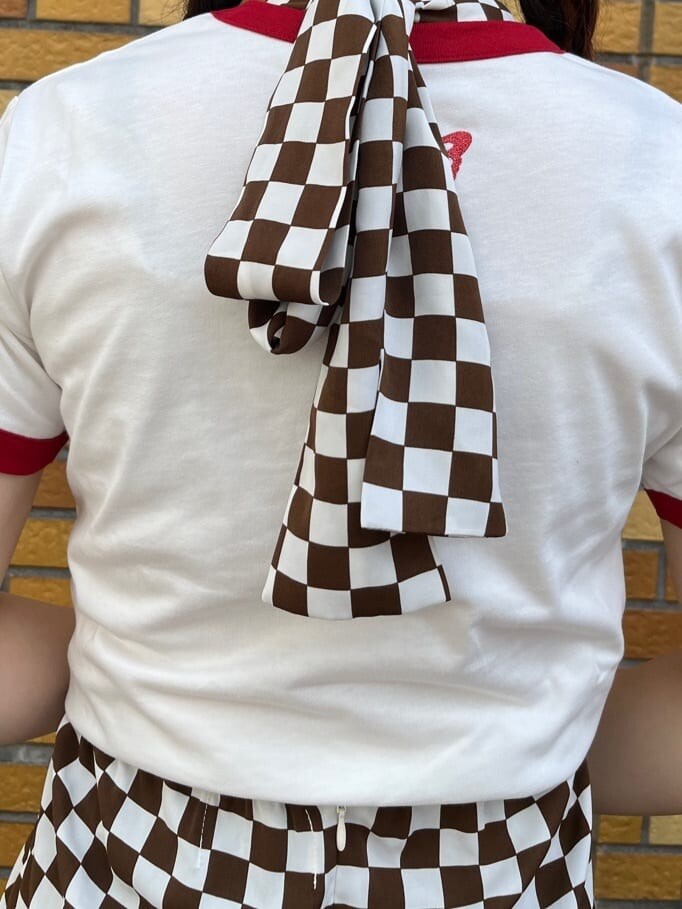 ブラック系のブーツ、ホワイト系のシャツ/ブラウス、ブラック系のハンドバッグを着用したレディースの夏コーディネートの6枚目の写真