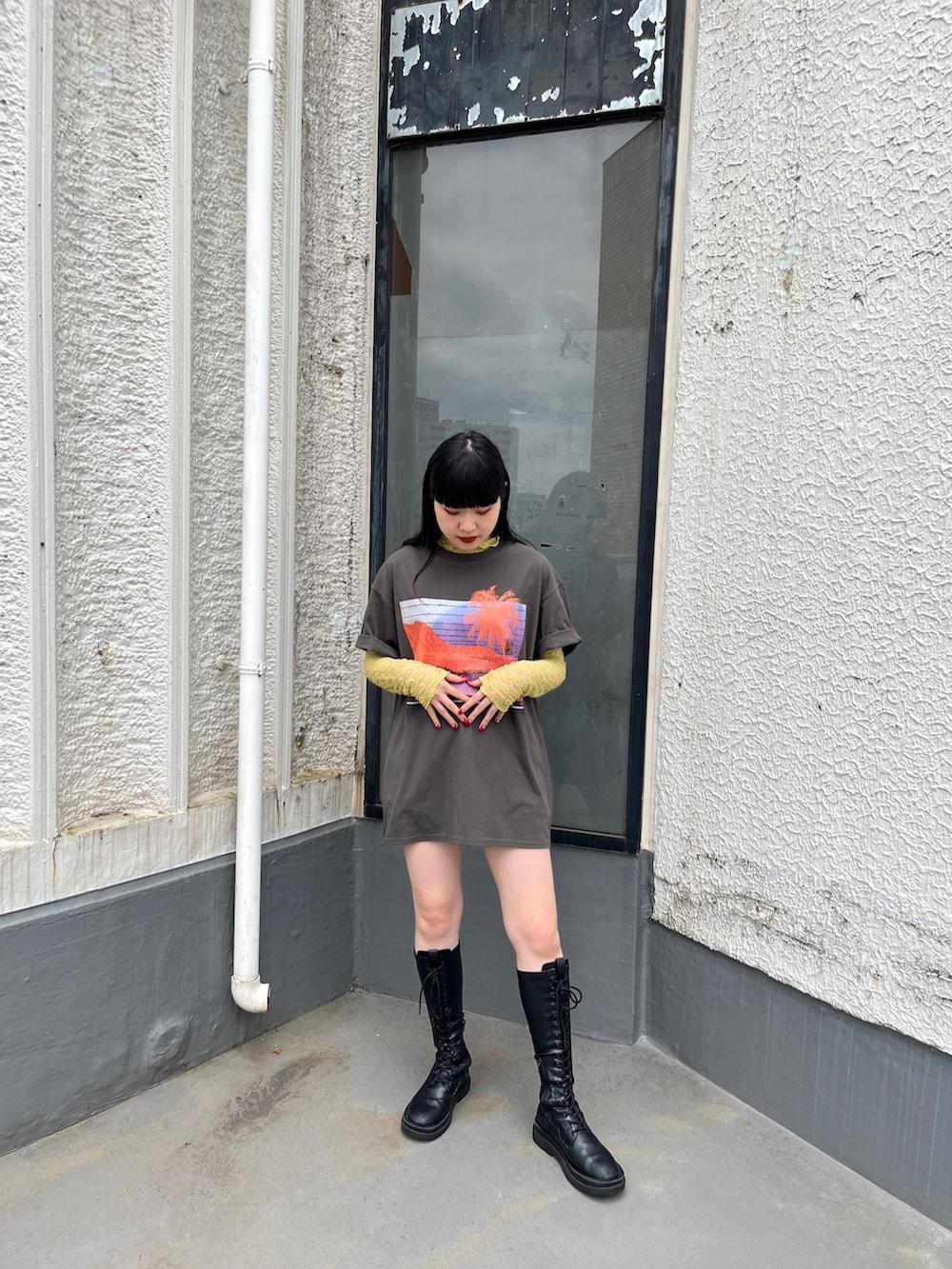 ブラック系のブーツ、イエロー系のTシャツ/カットソー、ブラック系のTシャツ/カットソーを着用したレディースの夏コーディネートの3枚目の写真