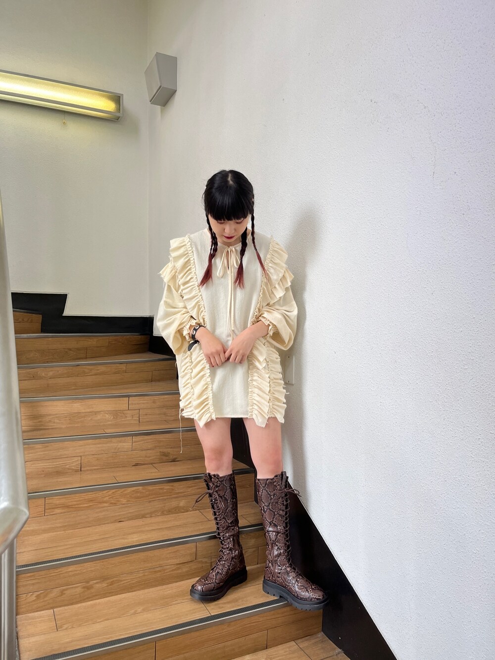 ブラック系のブーツ、ホワイト系のシャツ/ブラウス、ブラック系のデニムパンツを着用したレディースの冬コーディネートの3枚目の写真