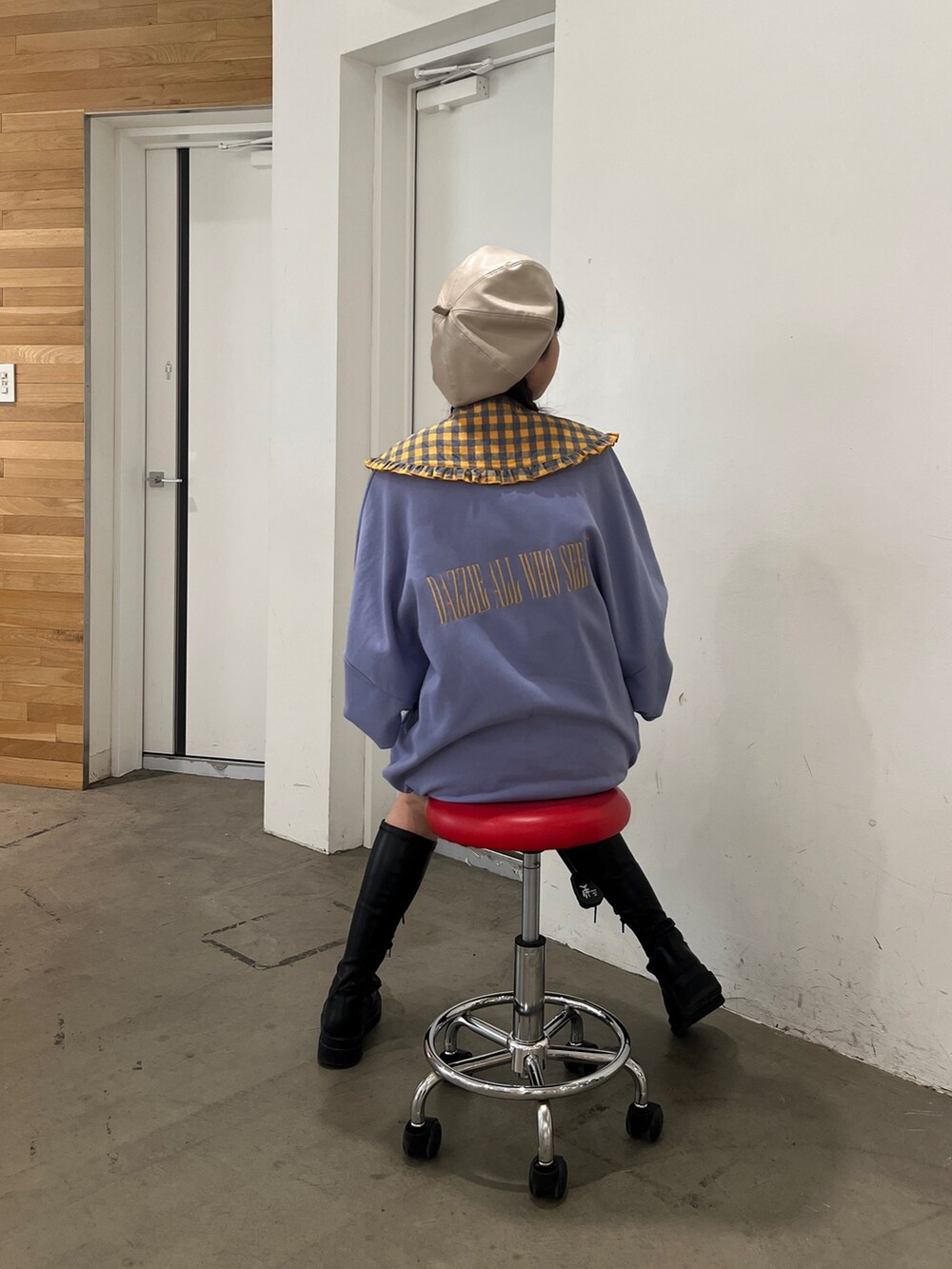 ブラック系のブーツ、パープル系のスウェット、ホワイト系のハンチング/ベレー帽を着用したレディースの秋コーディネートの3枚目の写真