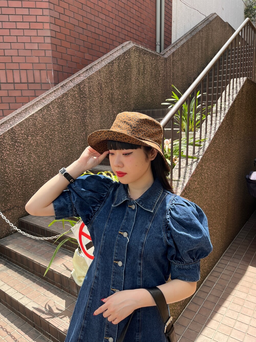 ホワイト系のショルダーバッグ、ブラック系のブーツ、ブルー系のワンピースを着用したレディースの春コーディネートの3枚目の写真