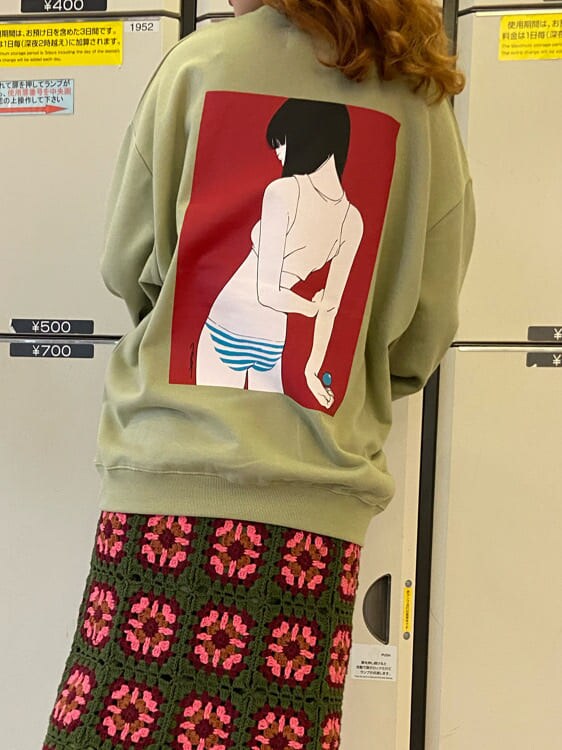 グリーン系のスカート、グリーン系のスウェットを着用したレディースの秋コーディネートの4枚目の写真