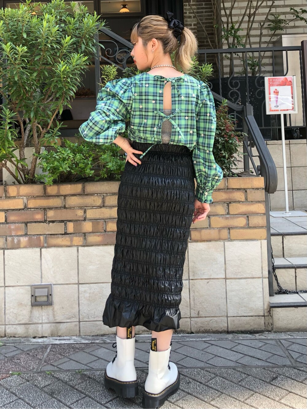 グリーン系のシャツ/ブラウス、ブラック系のスカートを着用したレディースの春コーディネートの2枚目の写真