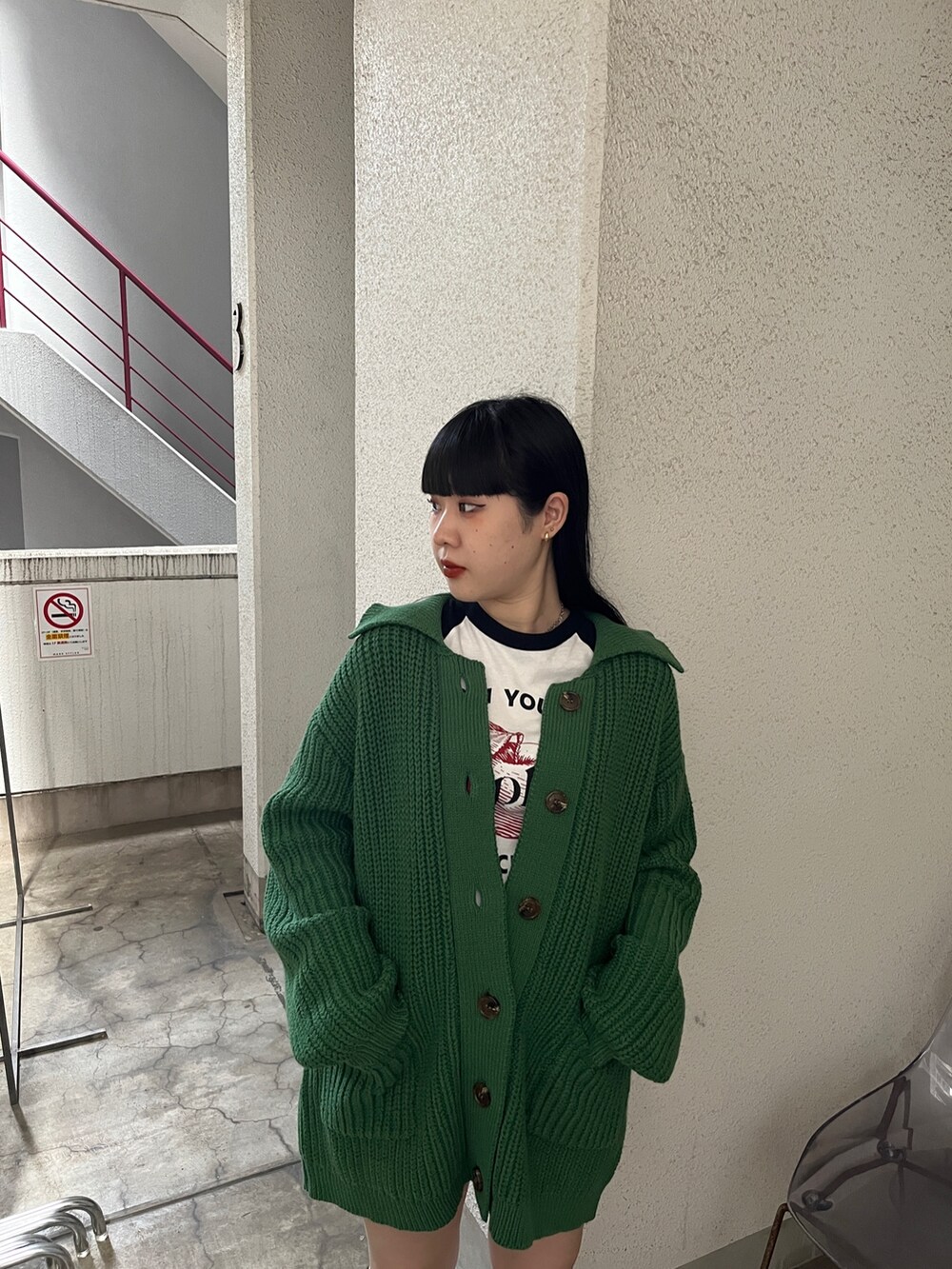 グリーン系のカーディガン/ボレロ、ホワイト系のTシャツ/カットソーを着用したレディースの秋コーディネートの4枚目の写真