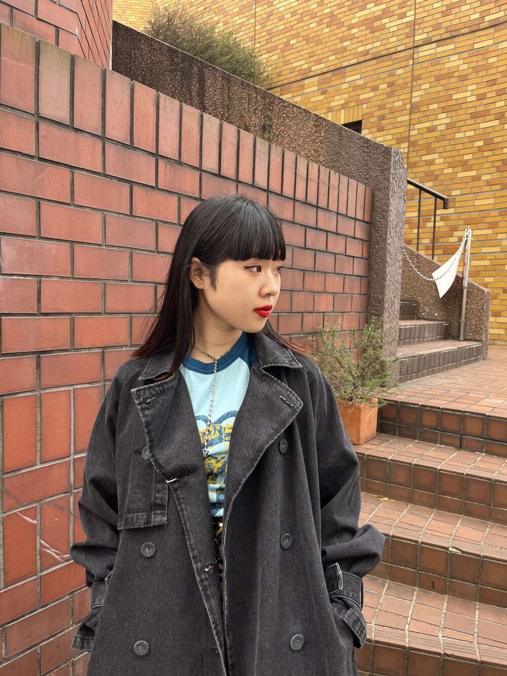 ブラック系のトレンチコート、ブラウン系のその他パンツ、ホワイト系のTシャツ/カットソーを着用したレディースの冬コーディネートの5枚目の写真