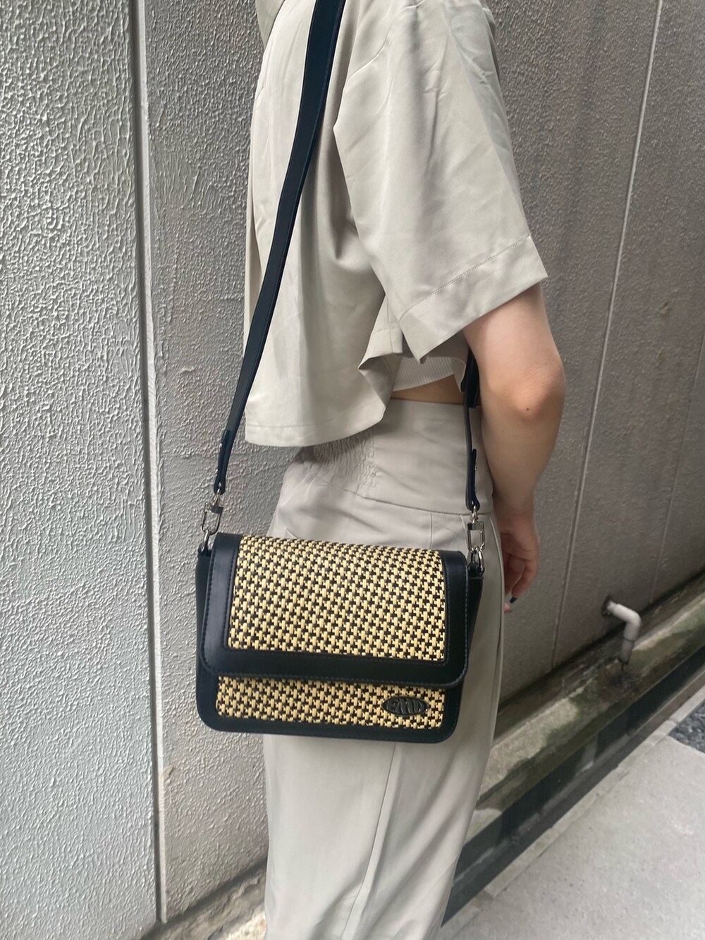 ベージュ系のその他パンツ、ホワイト系のキャミソール、ベージュ系のショルダーバッグを着用したレディースの夏コーディネートの9枚目の写真