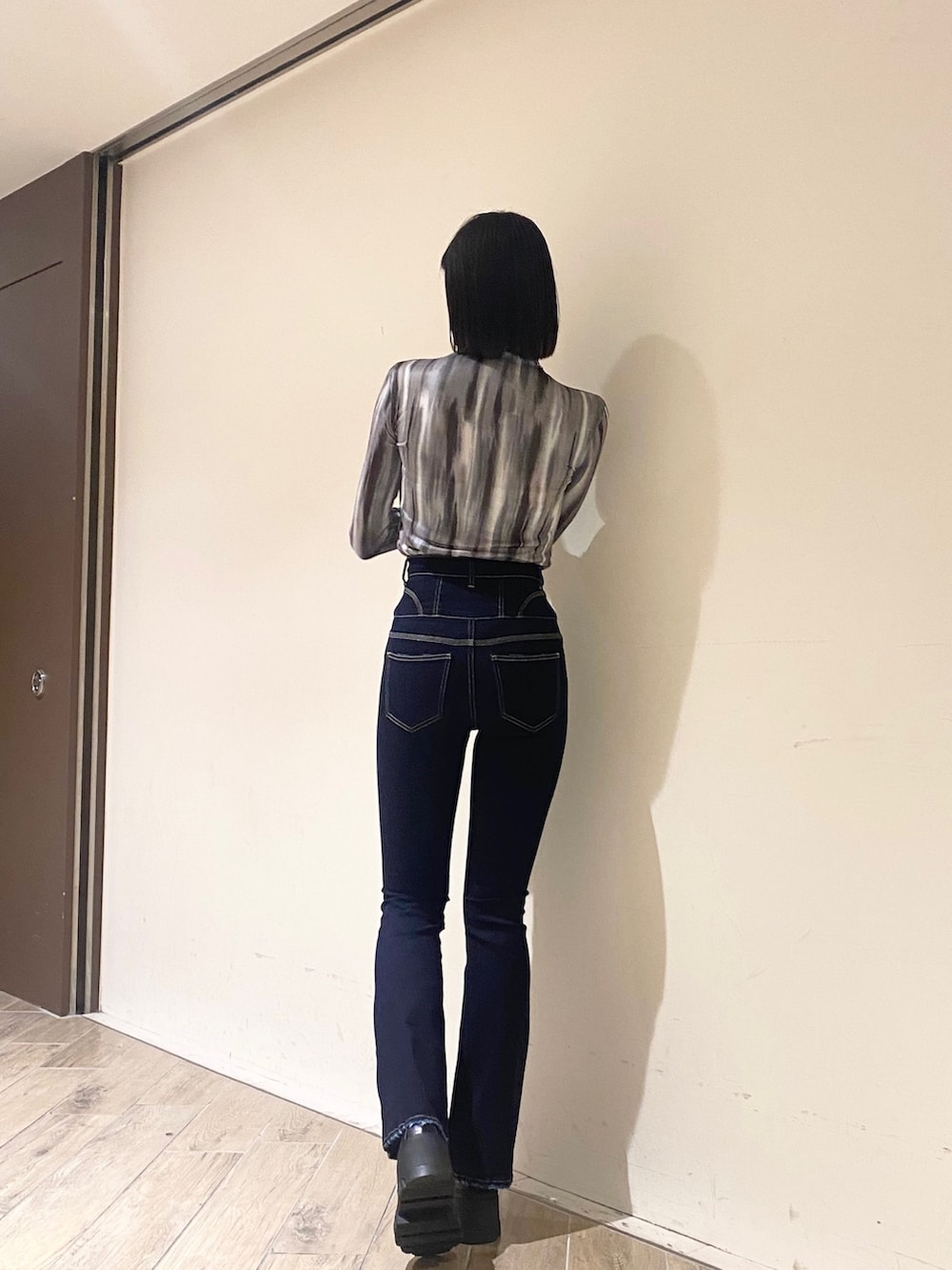 ブルー系のデニムパンツ、ブラック系のブーツ、ブラック系のMA-1を着用したレディースの秋コーディネートの5枚目の写真