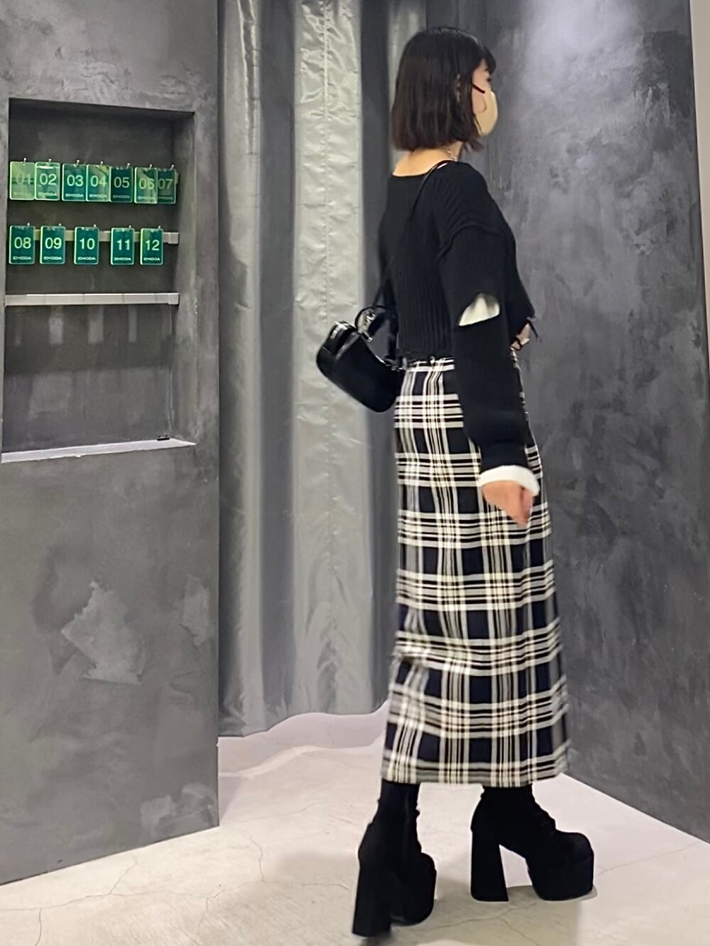 ブラック系のブーツ、その他のスカート、ブラック系のニット/セーターを着用したレディースの冬コーディネートの3枚目の写真