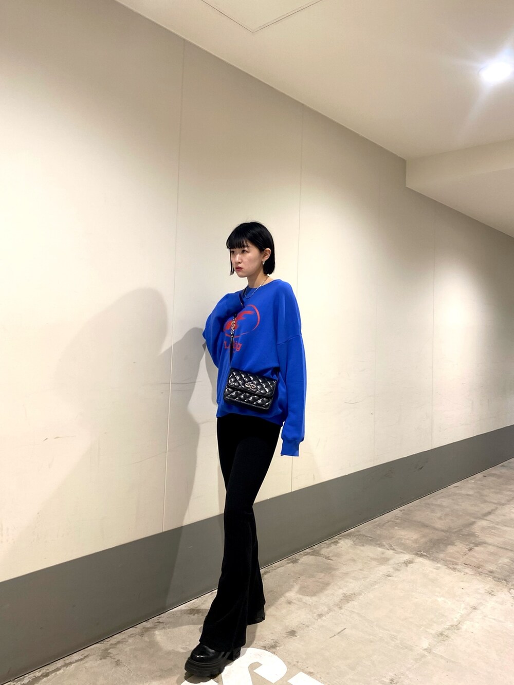 ホワイト系のブルゾン、ブラック系のその他パンツ、ブラック系のブーツを着用したレディースの冬コーディネートの7枚目の写真